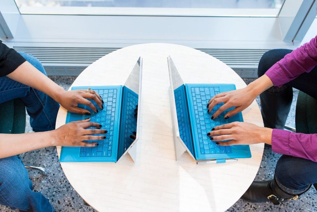 Developers collaborating around a laptop during a project planning session