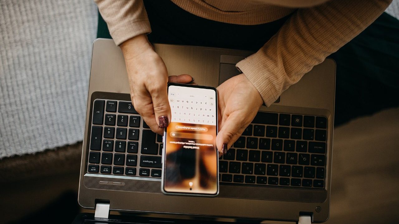 Business owner reviewing a mobile app budget with wireframes and a calculator on a desk
